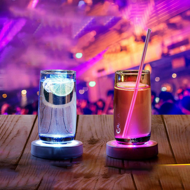 LED lighted barware coaster glowing on table with drink